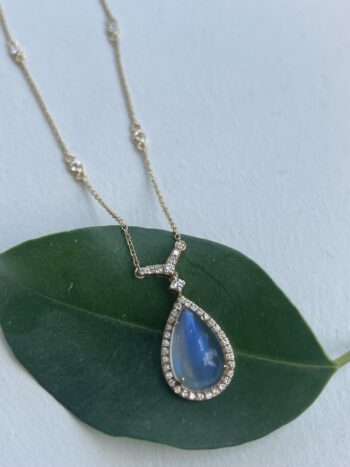 Pear cut blue rainbow moonstone necklace with diamond halo set in 18K yellow gold on adjustable chain