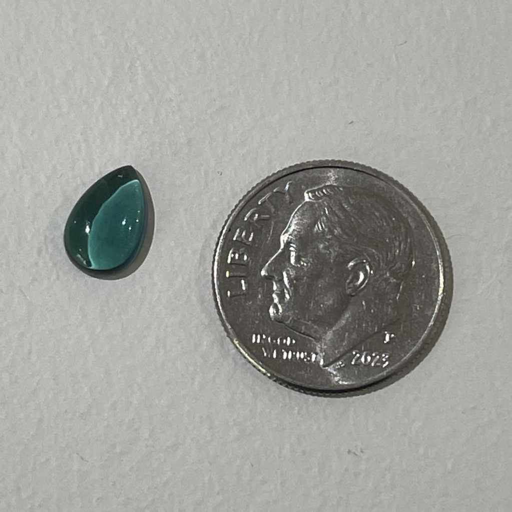 Pear shaped 1.26 carat green tourmaline cabochon with smooth polished surface