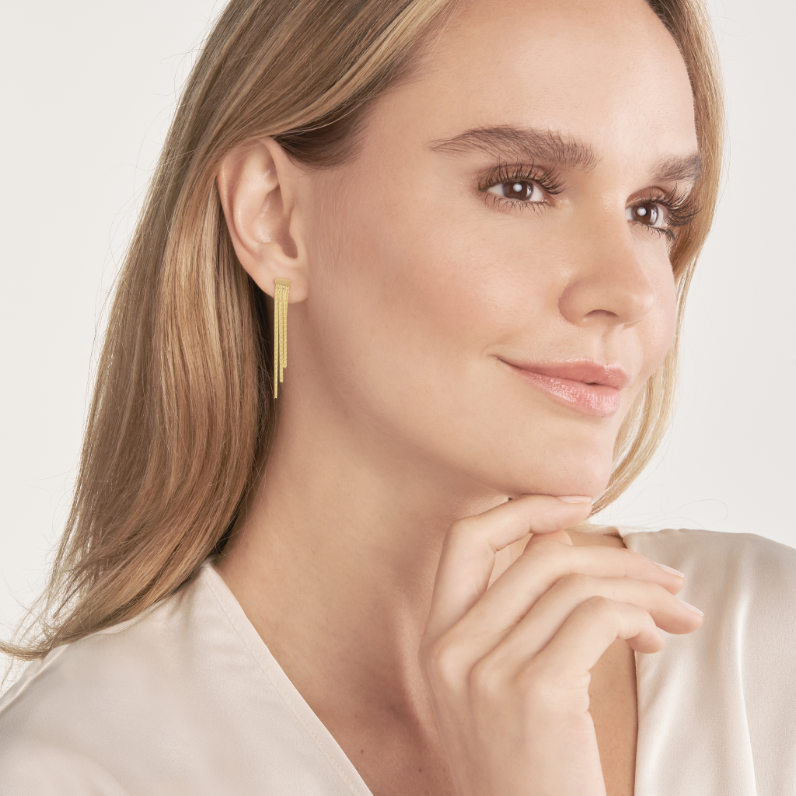 Delicate drop earrings in 14K yellow gold featuring slender post dangles softly catching light