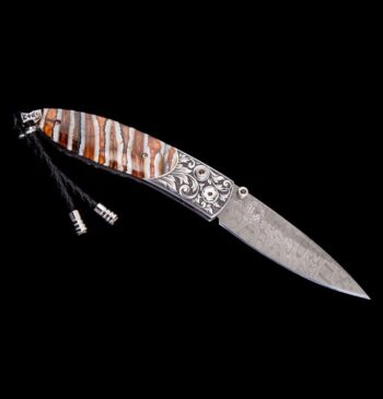 Jackson Monarch folding knife featuring a hand-engraved stainless steel frame and fossil Woolly Mammoth tooth handle