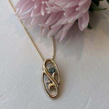 14K Yellow Gold Floral Oval Pendant featuring a green tourmaline and diamond accents