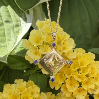 Heliodor pendant with light yellow gemstone and princess cut sapphire accents in 14K yellow gold